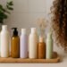 generada por ia Siete botes de champús veganos sobre bandeja de madera junto a melena rizada tipo 2B-3A, en baño luminoso y natural, aptos para el método Curly